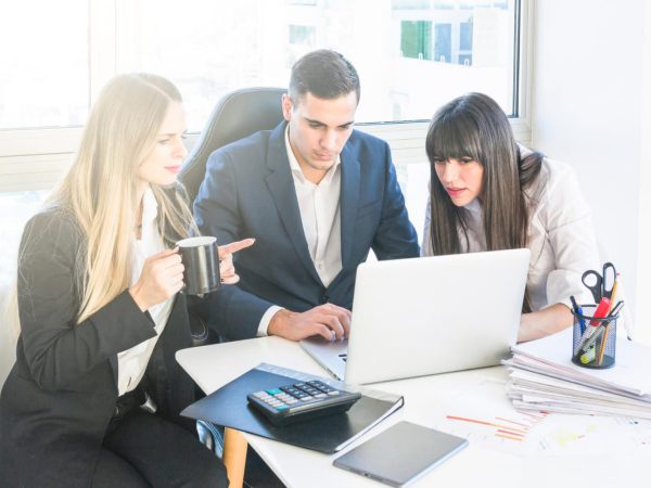 businessman-sitting-with-two-women-working-office (2)